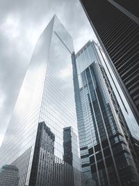 Low angle view of modern buildings in city against sky