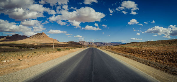 Empty road along countryside landscape