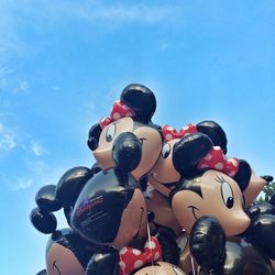 Low angle view of balloons against sky