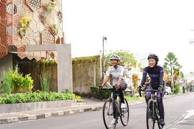 Rear view of man riding bicycle