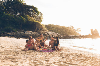 Friends enjoying at beach during summer