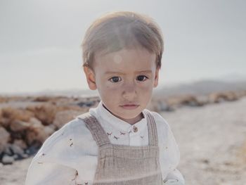Moody portrait of a kid walking in the desert
