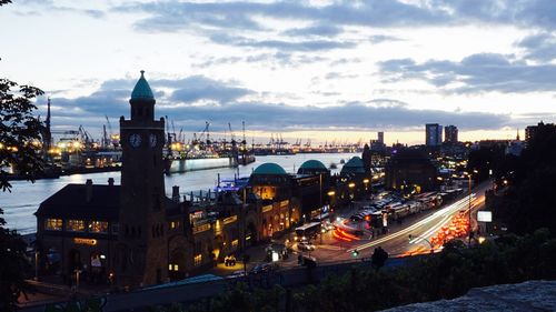 High angle view of illuminated cityscape against sky at dusk