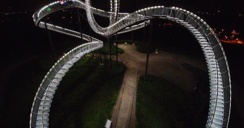 High angle view of illuminated ferris wheel at night