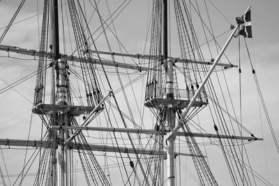 Sailboat sailing on rope against sky