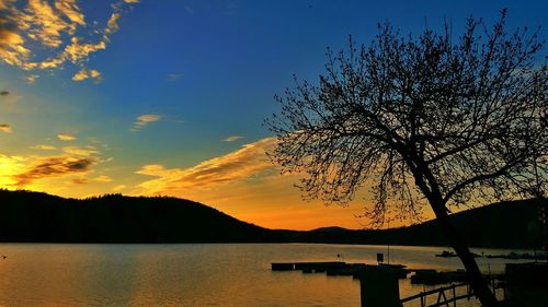 Scenic view of lake against sky during sunset