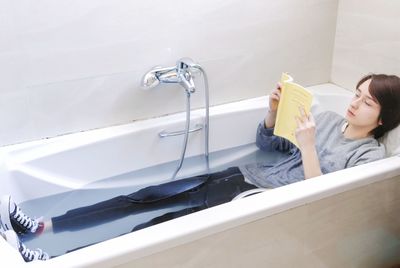 High angle view of woman relaxing in bathroom