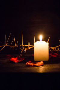 Close-up of illuminated tea light candles on table