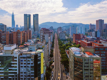 Panoramic view of buildings in city against sky