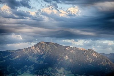 Scenic view of mountains against cloudy sky