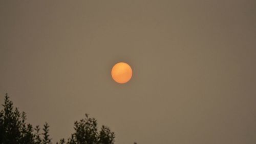 Low angle view of moon against sky at sunset