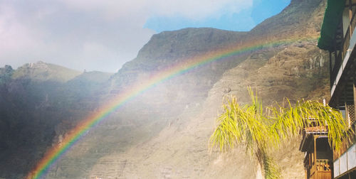 Rainbow over mountain against sky