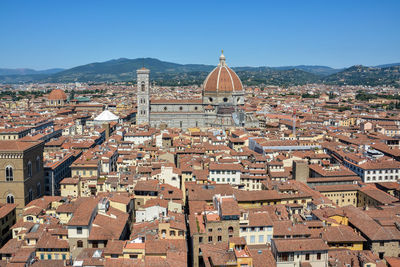 Aerial view of city buildings against clear sky