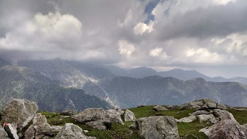 Scenic view of mountains against cloudy sky