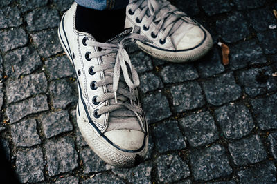 Low section of person standing on tiled floor