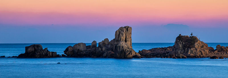 Panoramic view of rocks in sea against sky