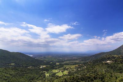 Scenic view of mountains against cloudy sky