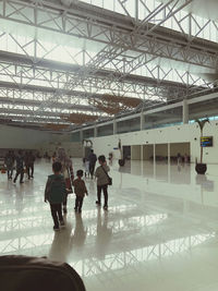 People walking on railroad station platform