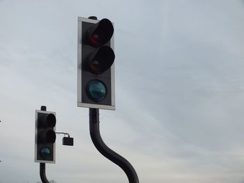 Low angle view of road sign against sky