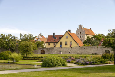 Houses and buildings against clear sky