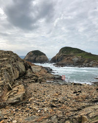 Scenic view of sea and mountains against sky