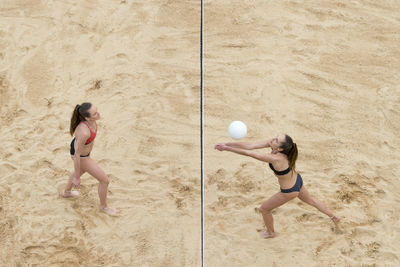 Woman playing with ball on sand