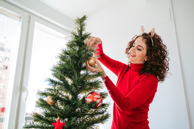 Midsection of woman holding christmas tree