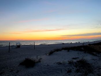 Scenic view of beach against sky during sunset