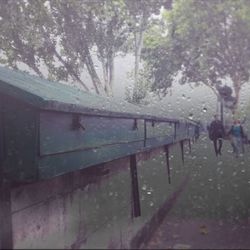 People walking on wet road during rainy season