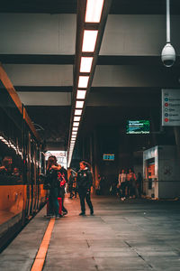 People walking on railroad station platform