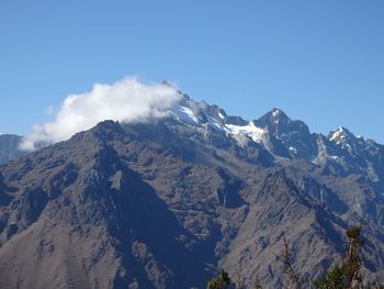 Scenic view of mountains against cloudy sky