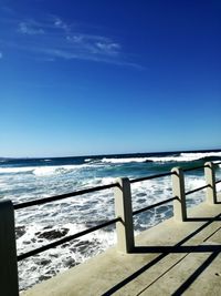 Scenic view of sea against clear blue sky