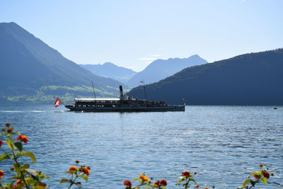 Scenic view of sea and mountains against clear sky