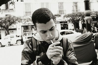 Portrait of young man with city in background