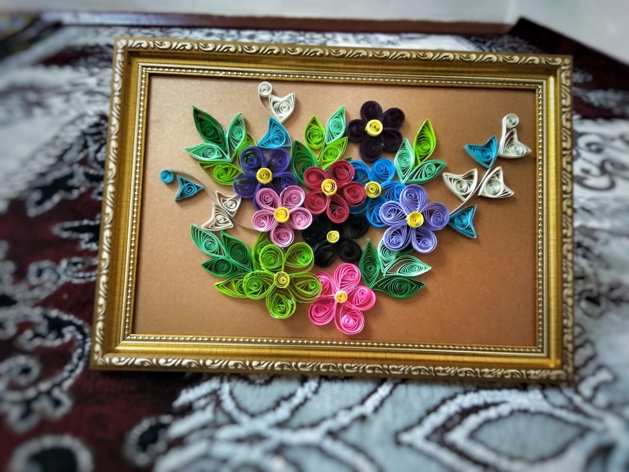 multi colored, still life, art and craft, indoors, high angle view, close-up, no people, design, creativity, craft, table, box, celebration, pattern, shape, directly above, decoration, star shape, box - container, floral pattern, ornate