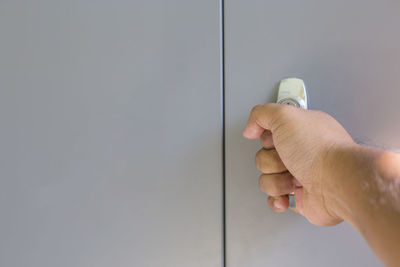 Close-up of man hand holding door handle