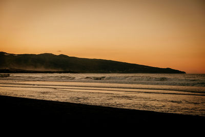 Scenic view of sea against clear sky during sunset