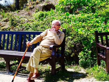 Man sitting on bench in park