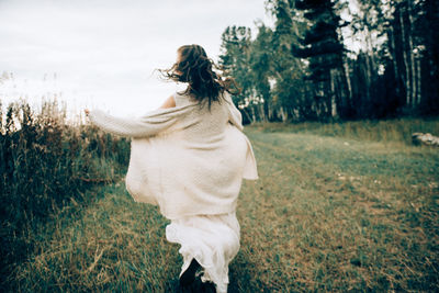 Rear view of woman on field