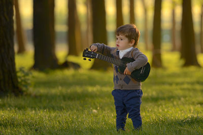 Full length of boy standing on field