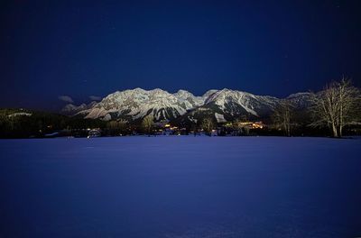 Scenic view of lake against sky at night