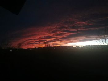 Silhouette landscape against sky during sunset