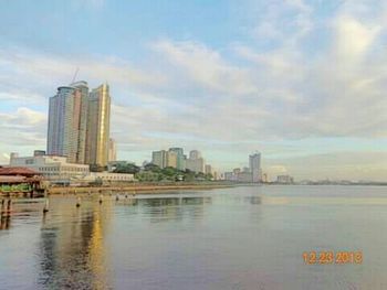 Cityscape against cloudy sky