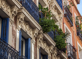 Historical houses in madrid, spain. balcony with plants, a colorful street in lavapiés neighborhood 