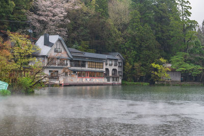 Kinrin lake with heavy rain, mist, and hotel in spring at  mount yufu, yufuin, oita, kyushu, japan. 
