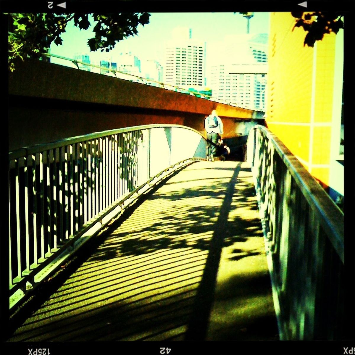 architecture, built structure, railing, the way forward, building exterior, transfer print, full length, sky, diminishing perspective, walking, sunlight, low angle view, footbridge, auto post production filter, men, connection, bridge - man made structure, day