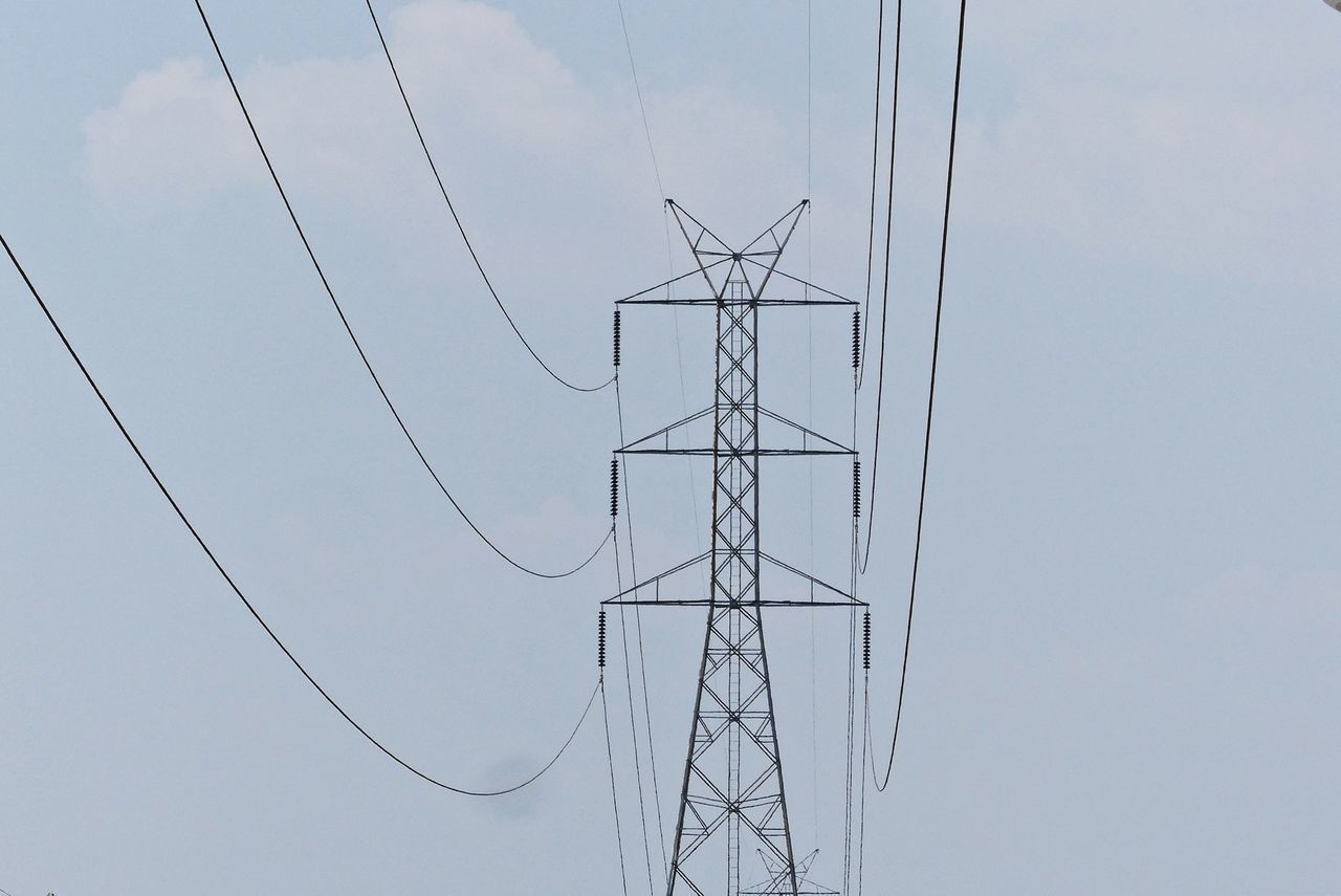 LOW ANGLE VIEW OF POWER LINE AGAINST SKY