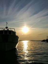 Sailboat on sea against sky during sunset