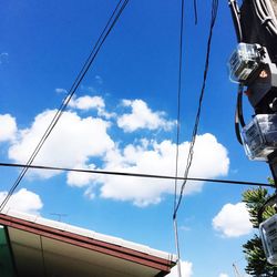 Low angle view of cables against blue sky