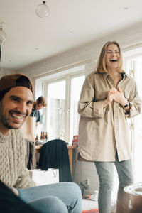 Portrait of happy woman standing at home